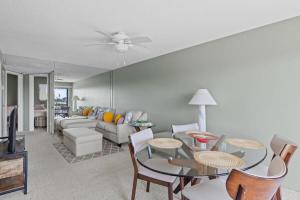 a living room with a couch and a table at Comfy Waterfront Condo at Tennisplace Sanibel in Sanibel