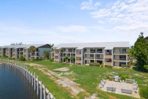 an aerial view of an apartment complex next to a body of water at Comfy Waterfront Condo at Tennisplace Sanibel in Sanibel