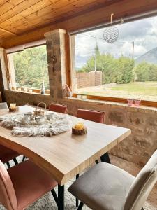 a wooden table and chairs in a room with a window at Crown Luxurious Residence in Arachova