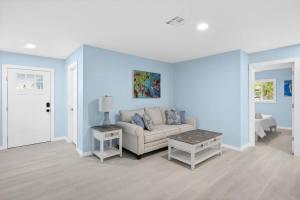 a living room with blue walls and a couch at Stunning Newly Renovated River District Residence in Fort Myers