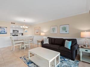 a living room with a couch and a table at South Seas Beach Villa 2426 - Stunning Beachfront Residence in Captiva