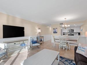 a living room with a couch and a dining room at South Seas Beach Villa 2426 - Stunning Beachfront Residence in Captiva