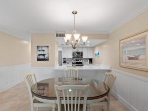 a dining room with a glass table and chairs at South Seas Beach Villa 2426 - Stunning Beachfront Residence in Captiva