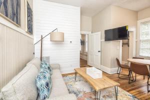 a living room with a couch and a table at Charming Condo in Historic Downtown Building in Wilmington