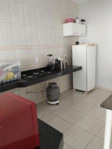 a kitchen with a stove and a refrigerator in it at Casa primavera caldas novas in Caldas Novas
