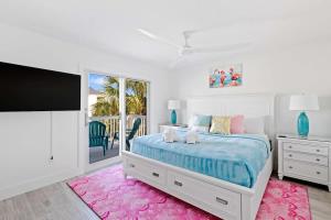a bedroom with a bed and a flat screen tv at Stunning Near Beach Residence on Palermo Circle in Fort Myers Beach