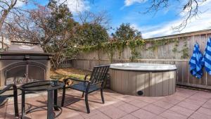 a hot tub and a table and a chair on a patio at Chocolate Diamond private hot tub walk to Main in Fredericksburg