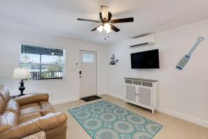 a living room with a couch and a ceiling fan at Gorgeous Beach Condo with Pool Spa and Bikes in Fort Myers Beach