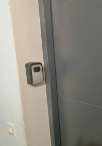 a bathroom door with a toilet paper dispenser on it at Przytulny apartament in Augustów