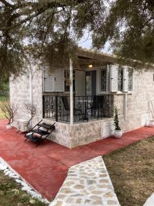 a house with a porch and a patio at Helios Beach House in Mikros Gialos