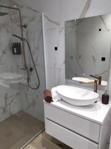 a white bathroom with a sink and a shower at Trees Fontain in Jalhay