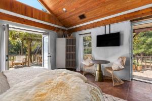 a bedroom with a bed and a television on a wall at Falling Star, Hot tub and Pet Friendly! in Fredericksburg +15 photos