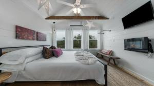 a bedroom with a large bed and a ceiling fan at Jumping Goat Ranch-Treehouse Amazing View in Fredericksburg