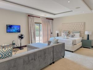 a large bedroom with two beds and a couch at Fullbliss Guesthouse in Johannesburg
