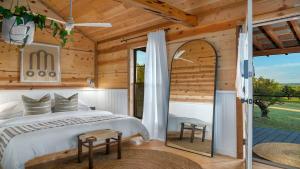 a bedroom with a bed and a large window at Sweet Paradise cabin with private hot tub in Fredericksburg