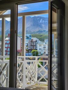 a view of a mountain through a window at Lennox Ushuaia in Ushuaia