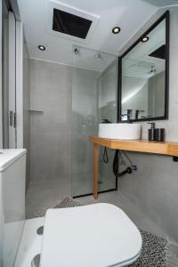 a bathroom with a sink and a mirror at Montis villa sea view heated pool in Daratso