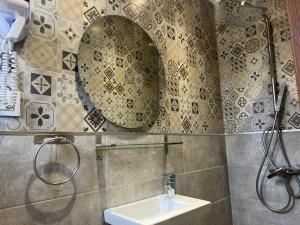 a bathroom with a sink and a mirror at Hotel Transatlantique Tunis in Tunis +24 photos