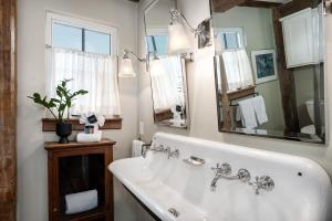 a bathroom with a sink and a large mirror at River Hill Ranch, great views & river access! in Flugrath +43 photos
