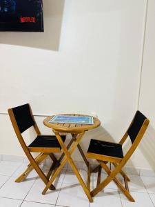 two chairs and a table with a glass top on it at Hidden MIA Apartment in Miami