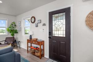 a living room with a black door and a table at Cherry Pond with hot tub & spectacular VIEWS in Fredericksburg
