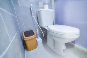 a bathroom with a white toilet and a trash can at Petra bods inn in Amman