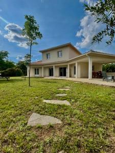 a large house with a lawn in front of it at VILLA PETRETO in Petreto-Bicchisano