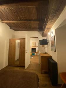 a bedroom with a bed and a desk with a television at Una pausa dalla città in Nepi +55 photos