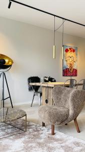a living room with a table and a chair at ApartmentInCopenhagen Apartment 1613 in Copenhagen