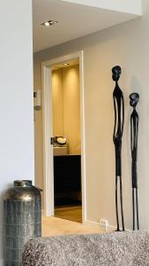 two black mannequins on a wall in a room at ApartmentInCopenhagen Apartment 1613 in Copenhagen