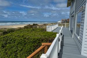 a house with a balcony with a view of the beach at Rascals Oceanfront Retreat in Florence