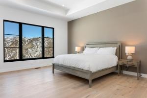a white bedroom with a bed and a window at 1665 Cordillera Way in Edwards