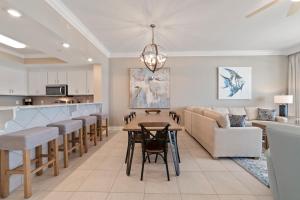 a kitchen and living room with a table and chairs at Luxury Gulf Front Condo Lazy River 704 in Orange Beach