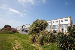 a row of apartment buildings on the side of a street at Bright & modern Sussex seafront home Great views in Selsey