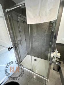 a shower with a glass door in a bathroom at Walkers paradise on the Pennine way Charlestown in Halifax