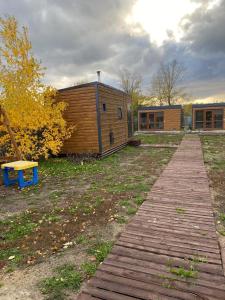 a wooden walkway leading to a building with a building at Module house - Burabay in Borovoye