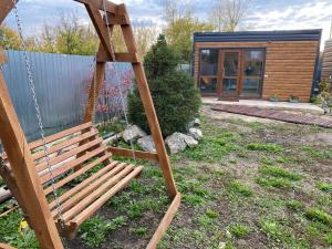 a swing in a yard with a house at Module house - Burabay in Borovoye +4 photos