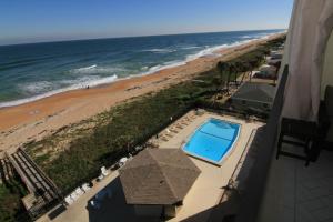 a view of the beach from the balcony of a condo at Luxury, Direct Oceanfront Unit and Balcony, Southeast Corner, Heated Pool, Garage Parking in Ormond Beach