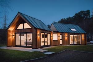 a house with a metal roof and glass windows at Newlands Lodges in Shotley Bridge