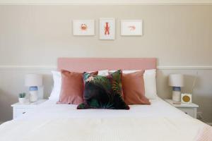 a bedroom with a white bed with pillows at Camber - King Room in Gastro Pub in West Wittering