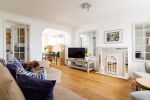 a living room with a couch and a fireplace at Wonderful Seafront Home - Panoramic Ocean Views in Selsey