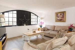 a living room with a couch and a table at Stylish City Centre Apartment with Sauna in Chichester
