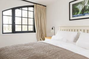 a bedroom with a large bed and a window at Stylish City Centre Apartment with Sauna in Chichester