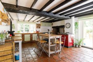 eine Küche mit einem Tisch und einigen Stühlen in der Unterkunft Tranquil Luxe in Country Cottage in Bosham