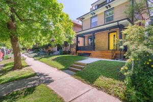 a house with a sidewalk in front of it at Sleek & Stylish Apt Steps From Bluebird Theater in Denver