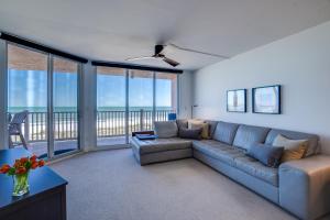 a living room with a couch and views of the ocean at Bella Luna, 2 bed and 2 bath beachfront condo in Bradenton Beach