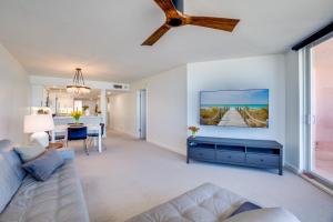 a living room with a couch and a tv on a wall at Bella Luna, 2 bed and 2 bath beachfront condo in Bradenton Beach +29 photos
