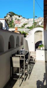 a table and chairs on a balcony with a view of a city at LuSi Capri House in Capri