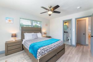 a bedroom with a bed and a ceiling fan at Beachtown Getaway with Tiki Hut in Pompano Beach