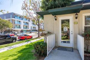 a house with a white door and a street with cars at Sunny Modern Studio Close to LAX in Los Angeles